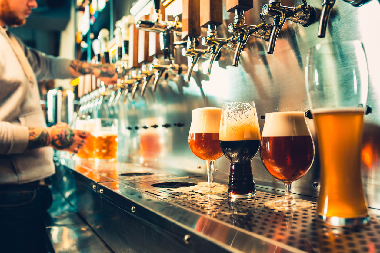 glasses of beer under tap