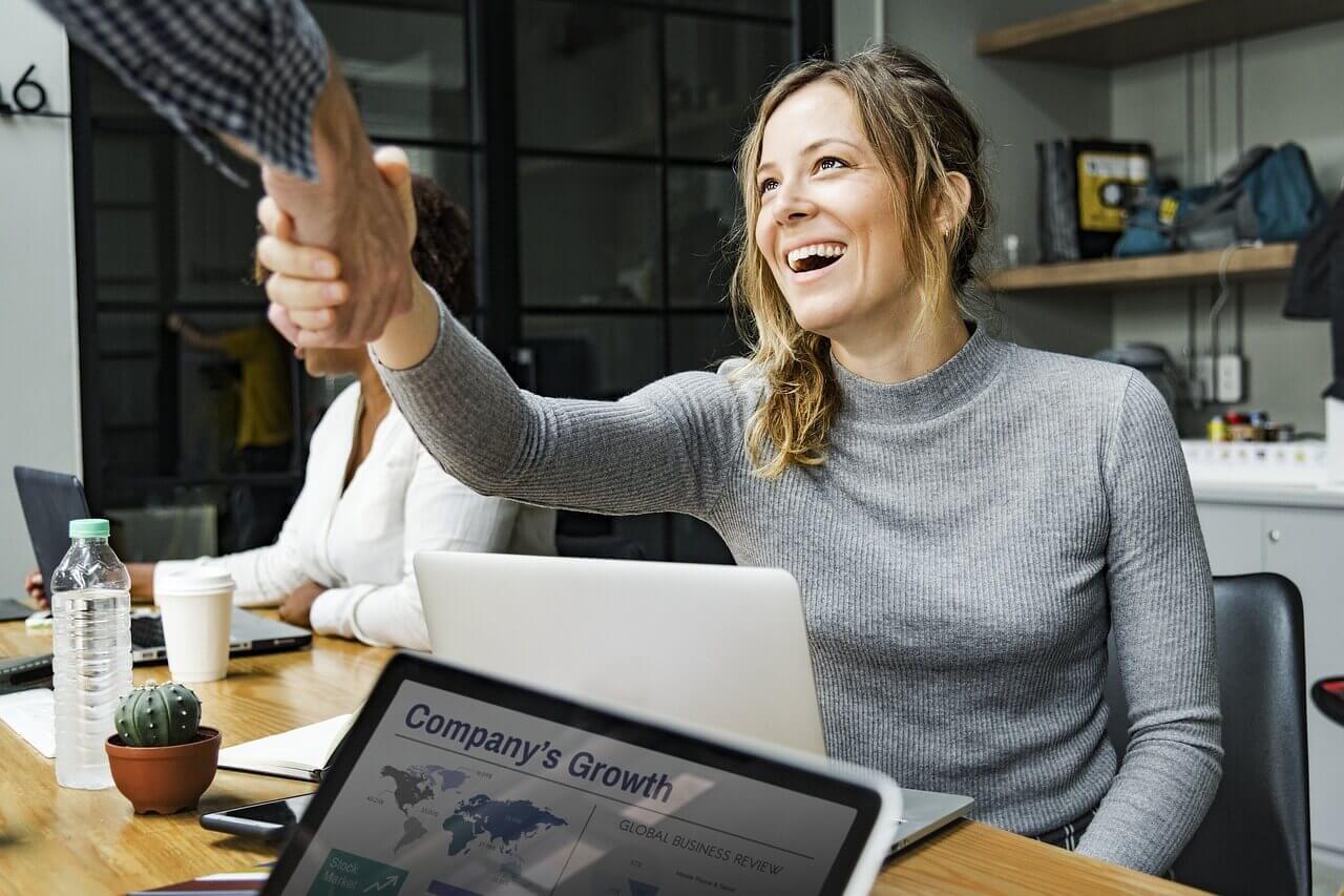 smiling woman shaking hand