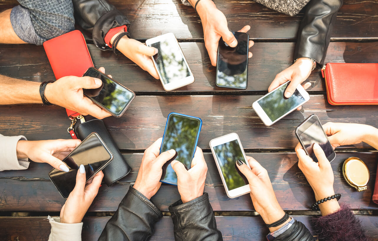 Group of people with smartphones in their hands