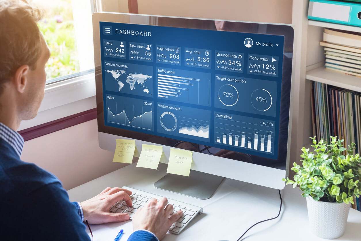 marketing person at desk with computer statistics