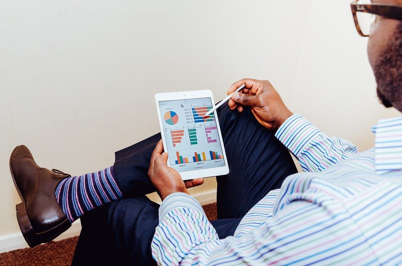 person viewing charts on tablet