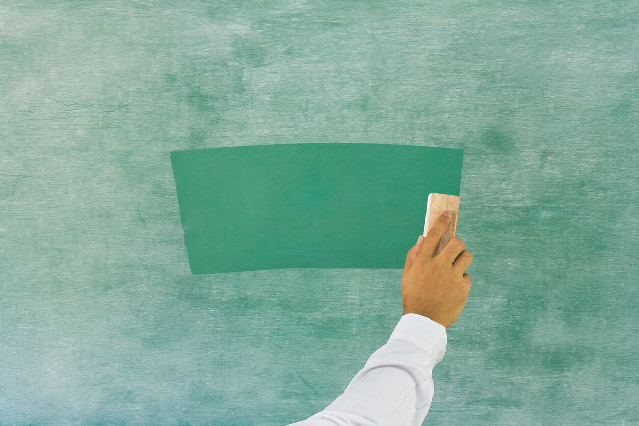 Hand erasing a chalkboard