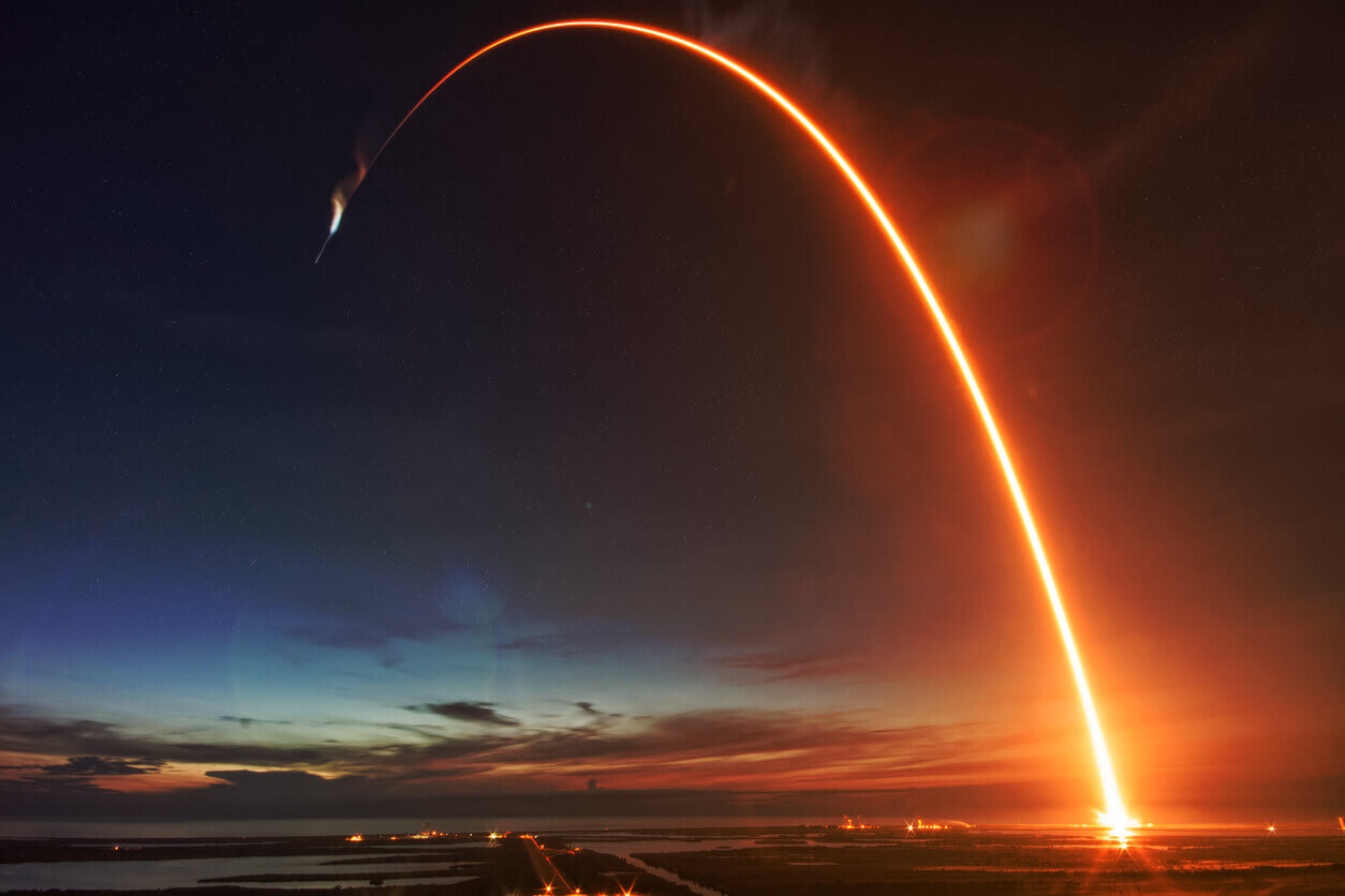 orange arc of light in night sky