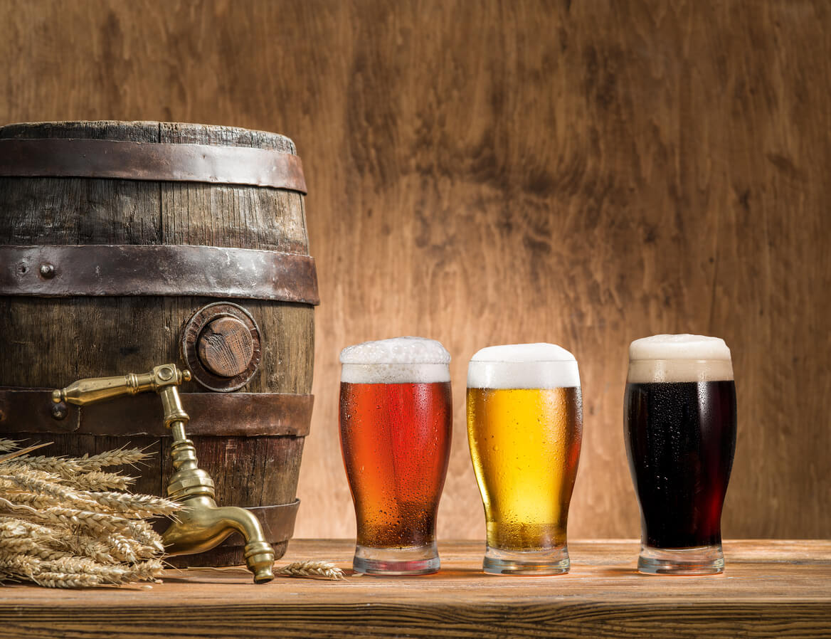 glasses of beer on wood background