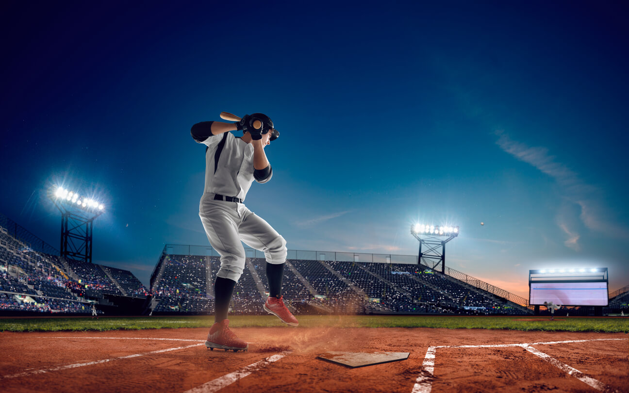 Pitcher in stadium winding up to throw the ball