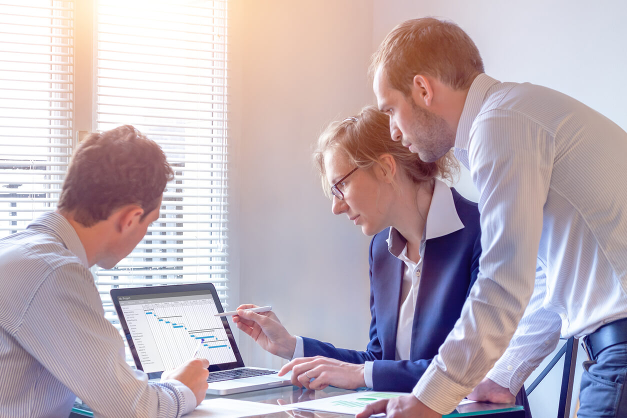 boss with employees in conference room