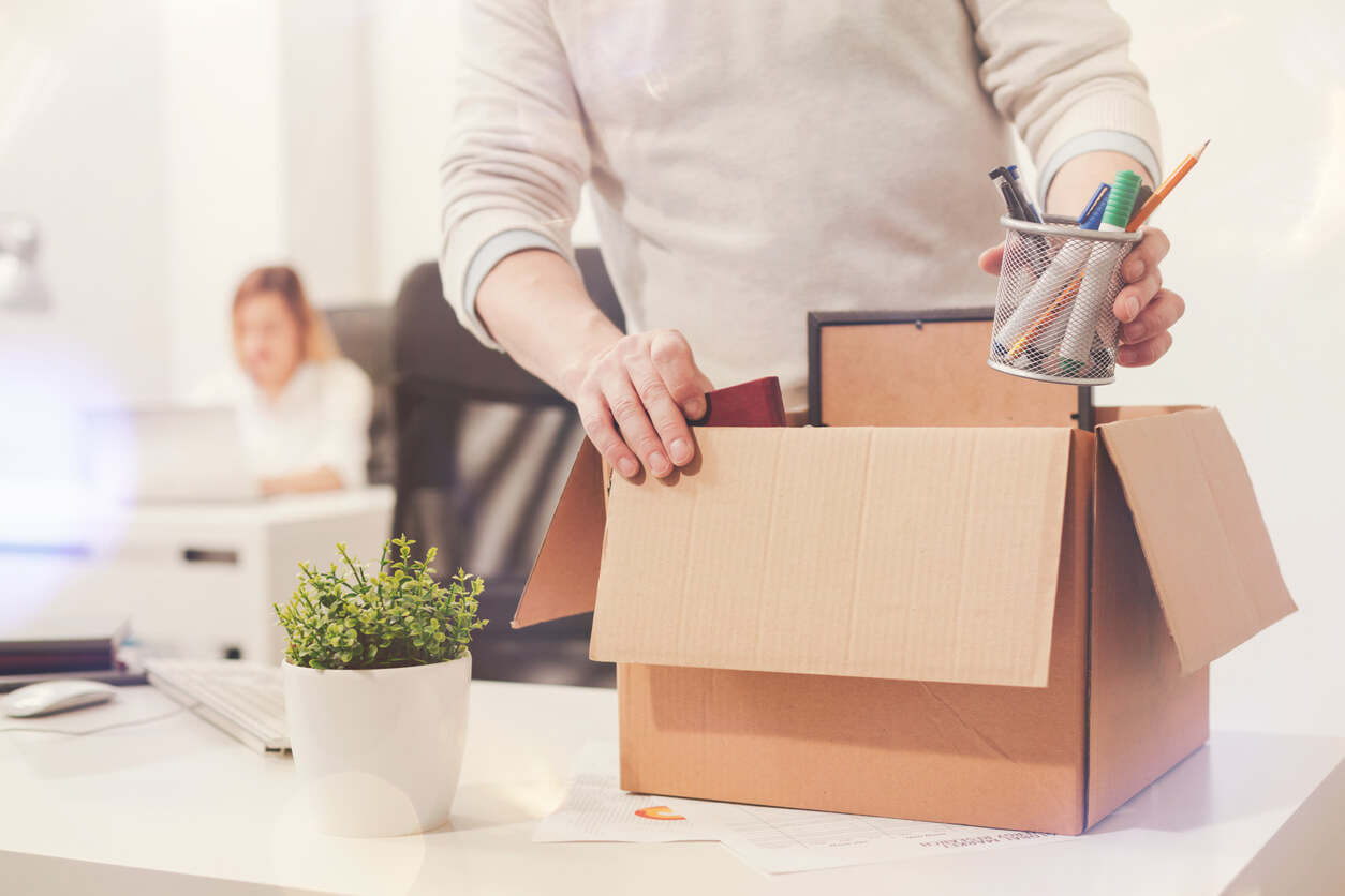 Sad dismissed worker taking his office supplies with him