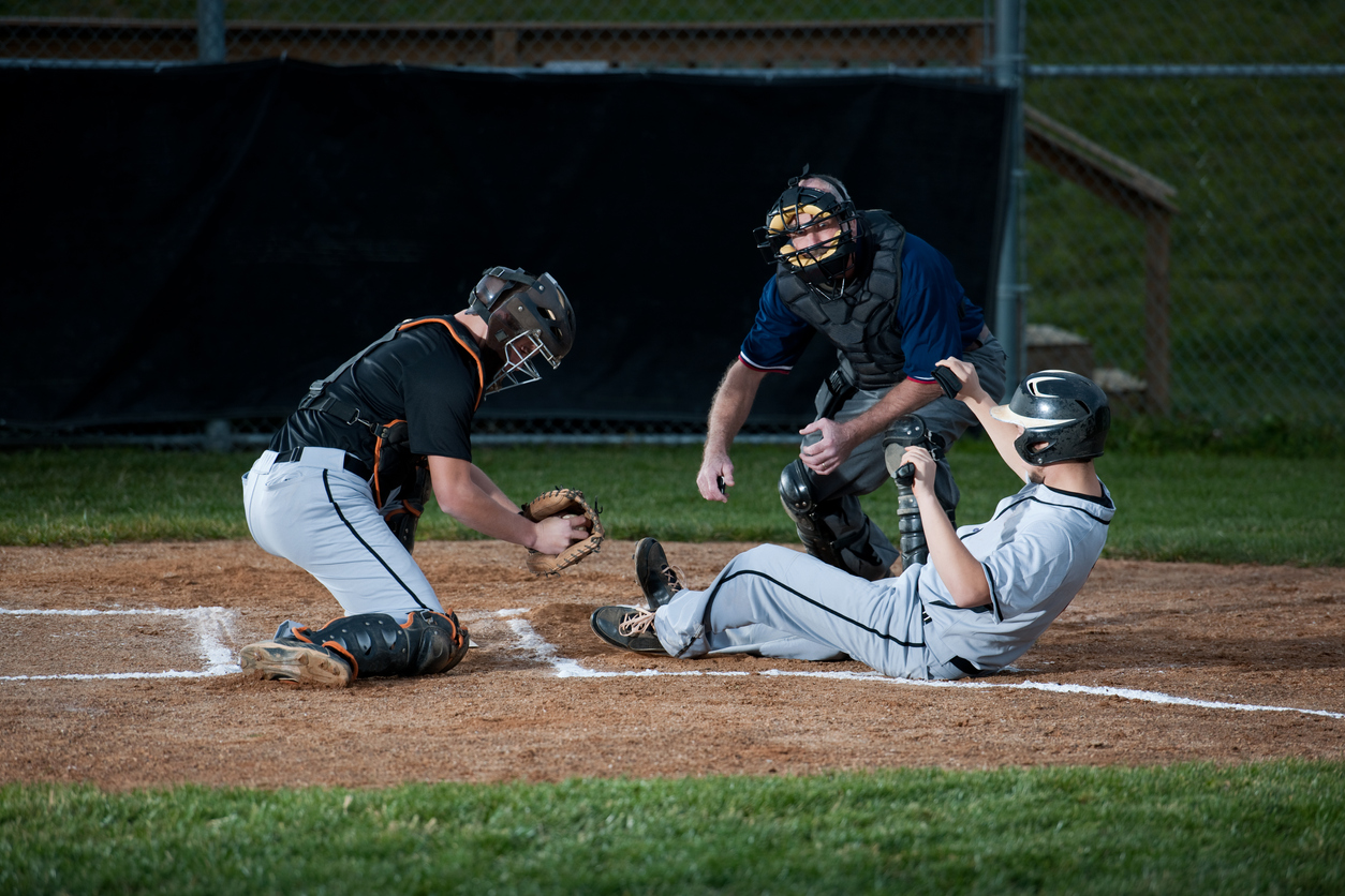 Baseball player sliding into home plate