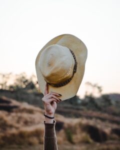 Picture of hand raising a hat