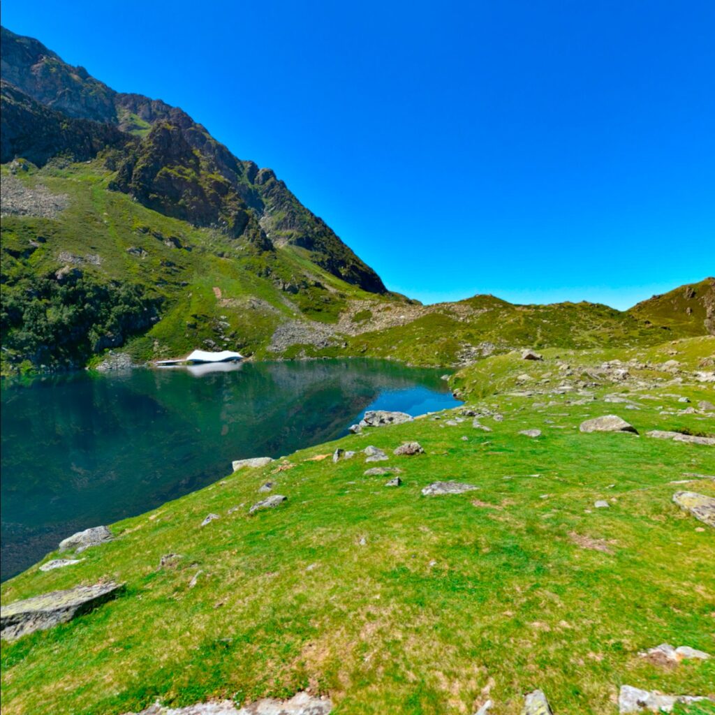 A 360-degree photo of mountains in the Supernatural app is static but includes algorithmically animated water on the surface of an alpine lake.