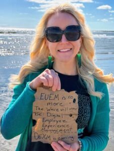 Analyst Christy Punch holding a note that shares the news that the EUEM Solutions Wave report will change names to DEXM Solutions.