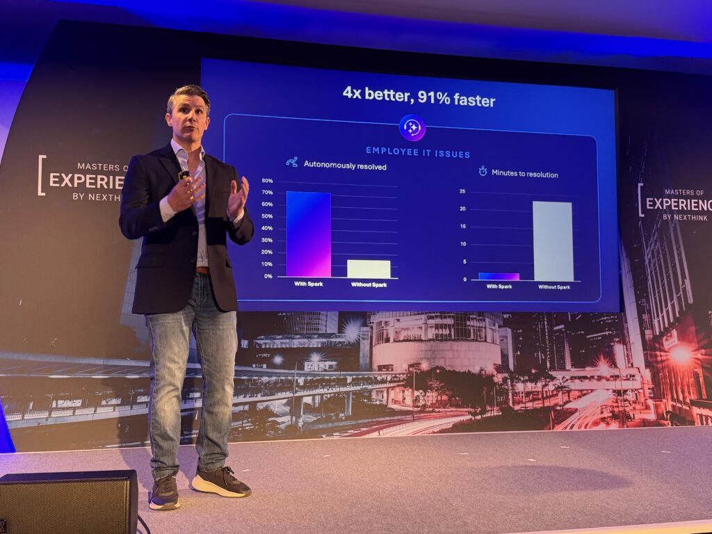 Nexthink CEO Pedro Bados standing in front of a slide with charts showing the positive impacts of AI for self-service employee support.