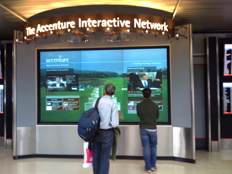 THis is a picture of a screen for the Accenture Interactive Network, at American's terminal at O'Hare